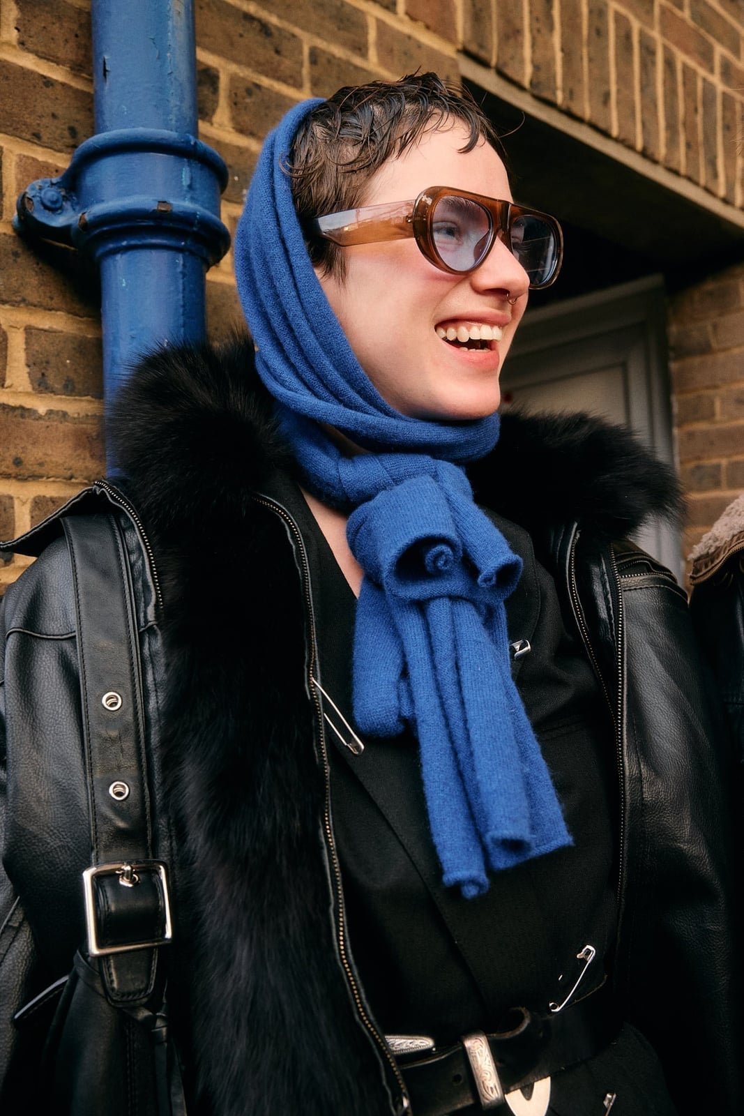 Oversized Black Leather Jacket with Blue Knit Accents — Trendy Photoshoot Outfits