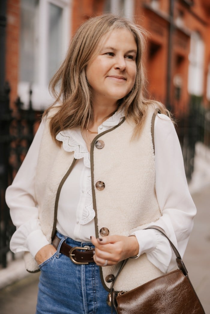 Cozy Cream Shearling Vest Over Ruffled Blouse and Jeans — Trendy Photoshoot Outfits