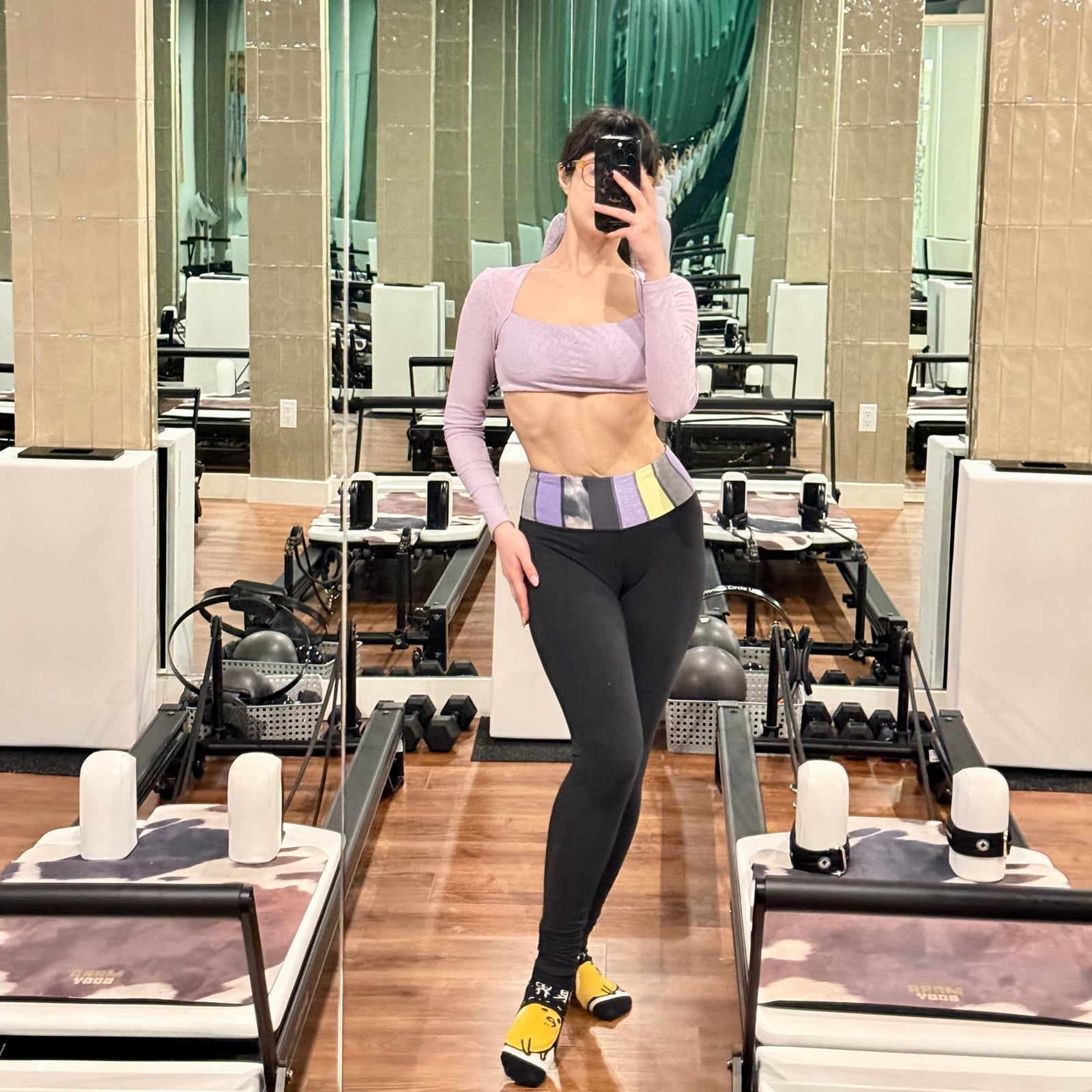 Lavender Crop Top Over Bra with Black Leggings and Yellow Shoes — Trendy Pilates Outfits
