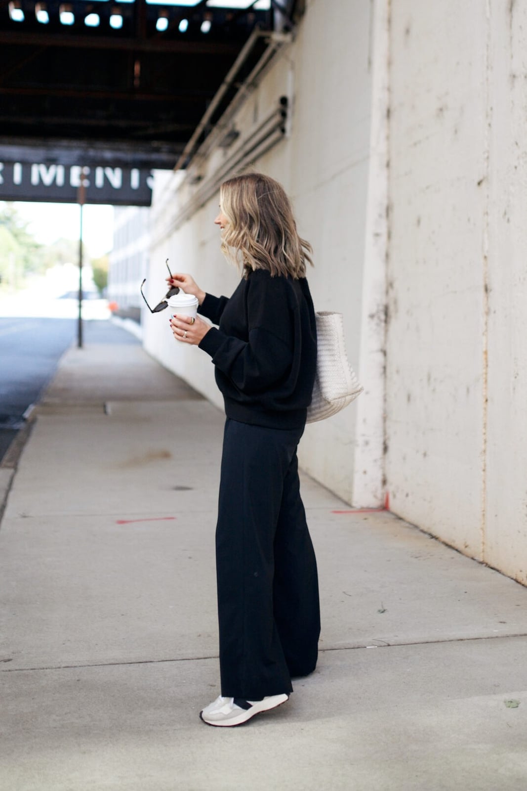 Black Oversized Sweatshirt with Wide-Leg Pants and Tote, Close-Up Take — Trendy Pilates Outfits