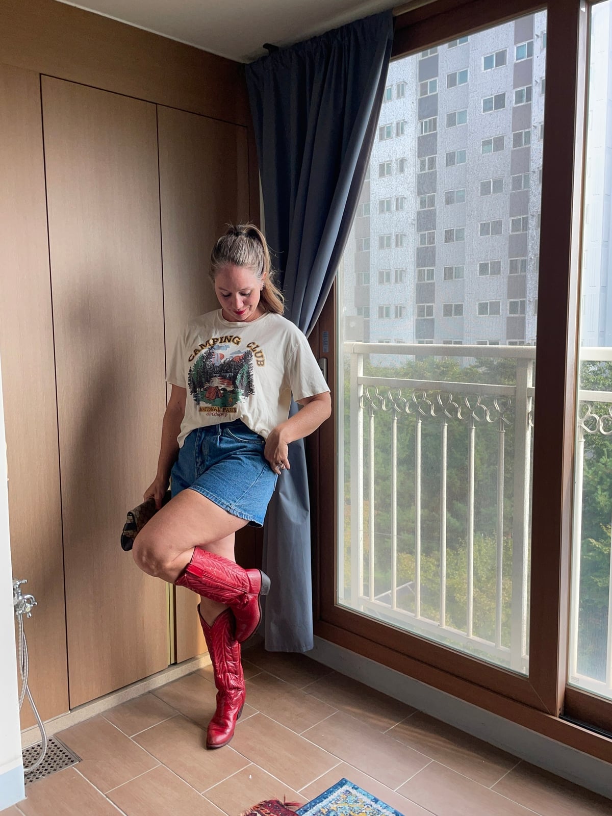 Red Cowboy Boots With Graphic Tee and Denim Shorts — Trendy Red Cowboy Boots Outfit
