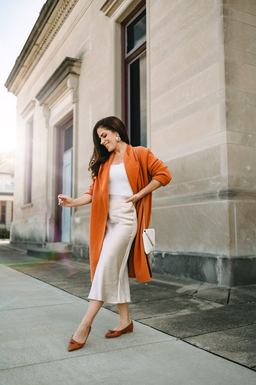 Cream Satin Midi Skirt With Orange Coat — Trendy Satin Skirt Outfits