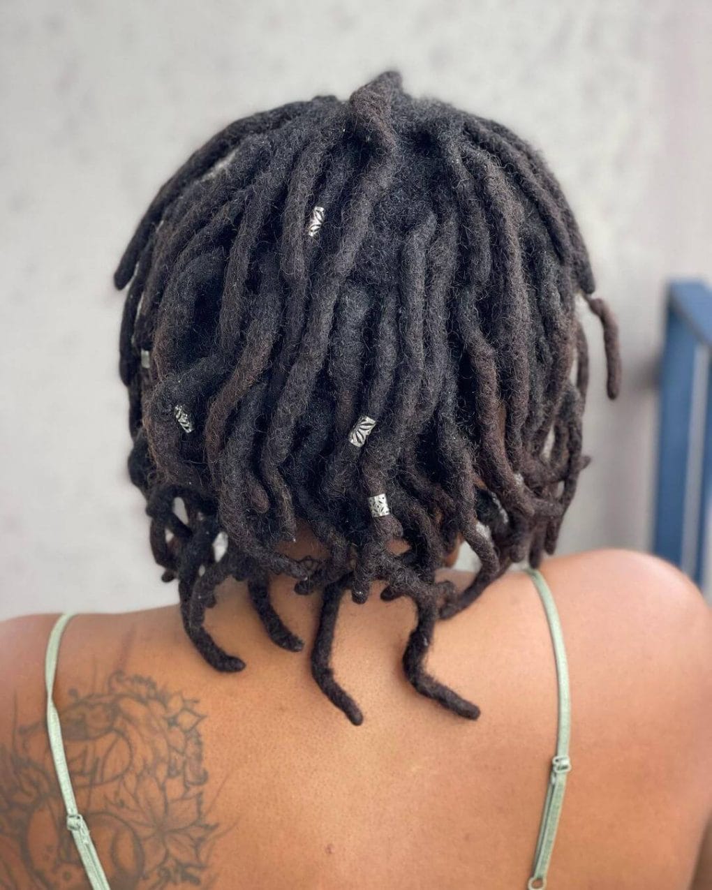Collarbone Locs Adorned With Silver Beads Collarbone Locs Adorned With Silver Beads — Trendy Short Locs