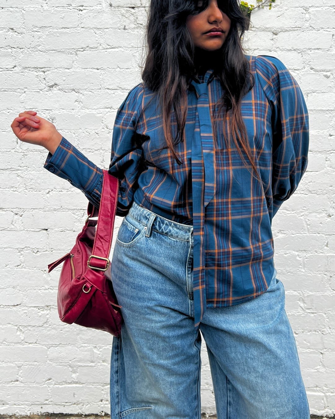 Red Shoulder Bag with a Blue Plaid Blouse and Straight-Leg Jeans — Trendy Shoulder Bag Outfits