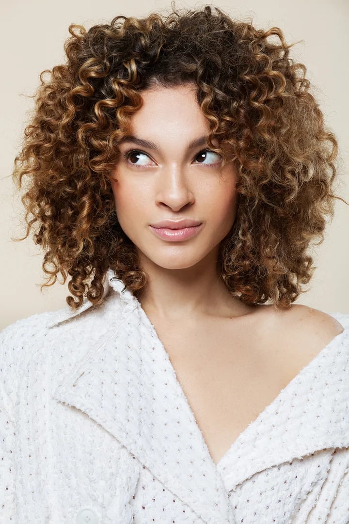 Collarbone Spiral Curls With Caramel Highlights — Trendy Shoulder Length Curly Hair