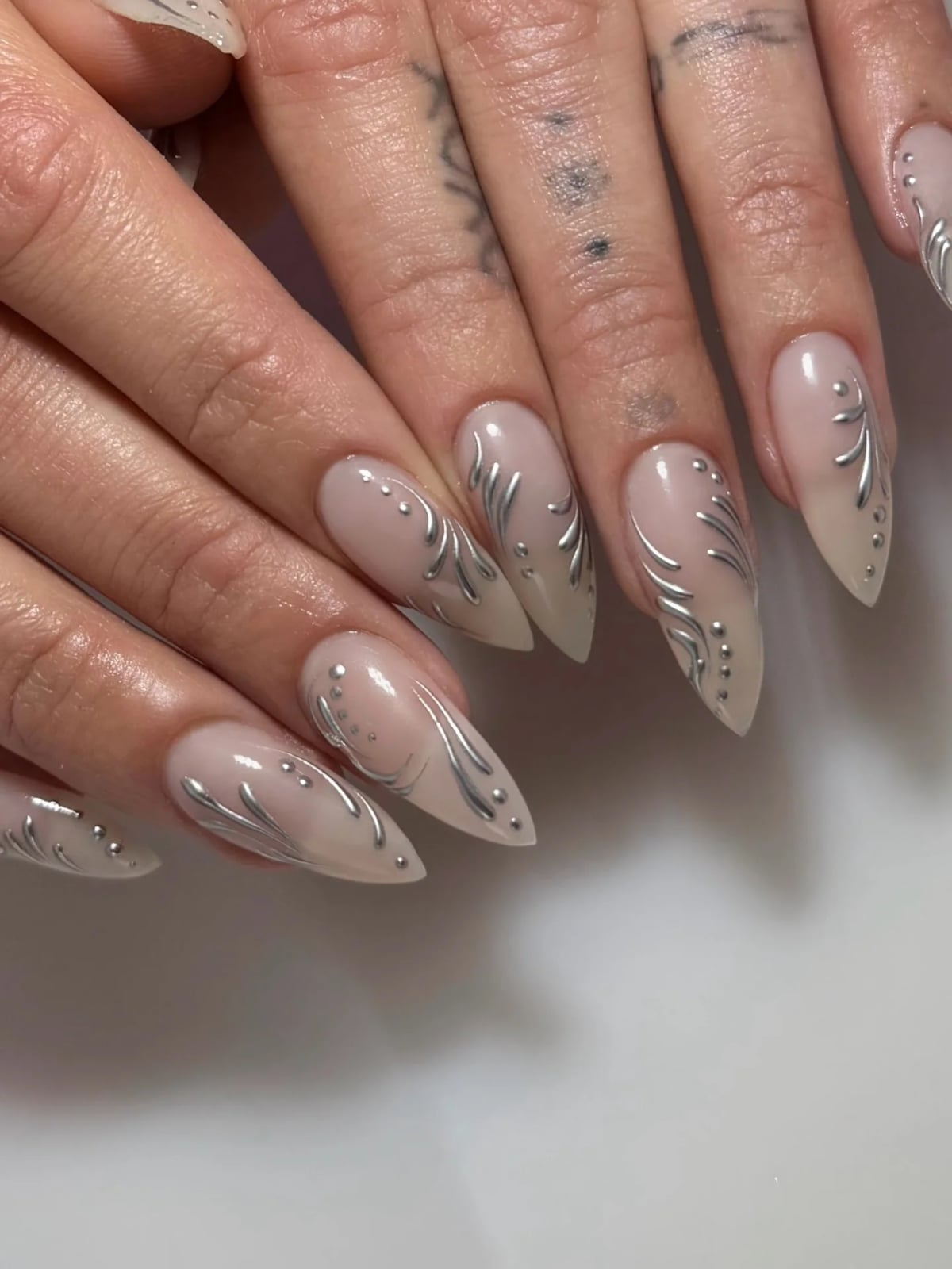 Silver Foil Swirls Dots Medium-Long Stiletto Nails Silver Foil Swirls Dots Medium-Long Stiletto Nails — Trendy Silver Chrome Nails