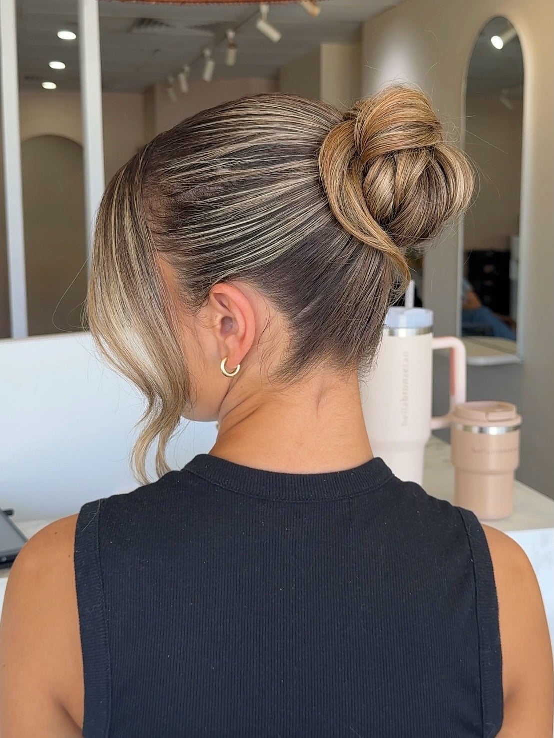 Blonde High Bun With Intricate Detail — Trendy Slick Back Hairstyles