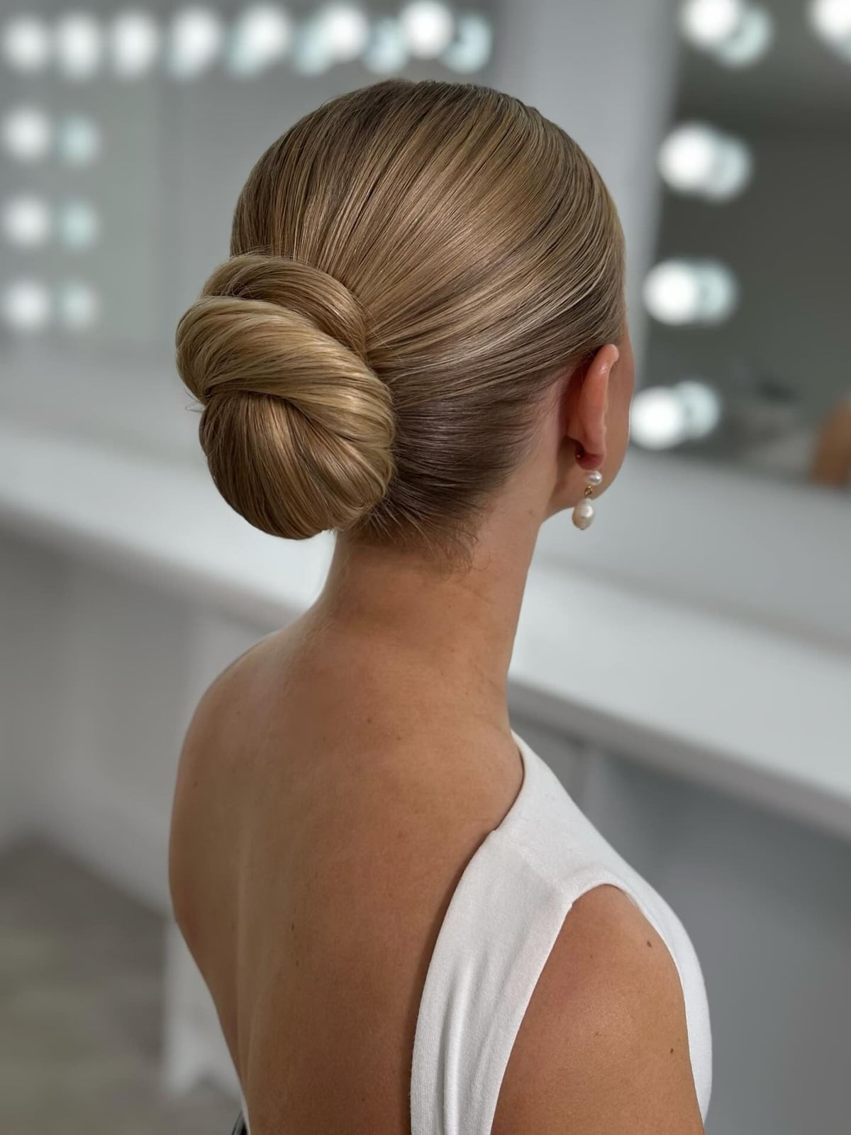 Smooth Blonde Chignon At The Nape — Trendy Slick Back Hairstyles