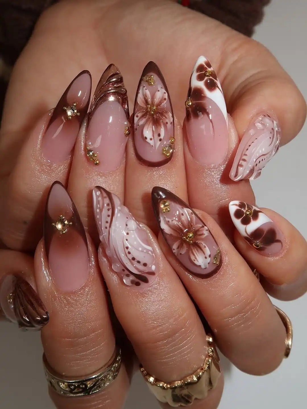 Pink Nude Stilettos With 3D Flowers and Gold Accents Pink Nude Stilettos With 3D Flowers and Gold Accents — Trendy Stiletto Nails