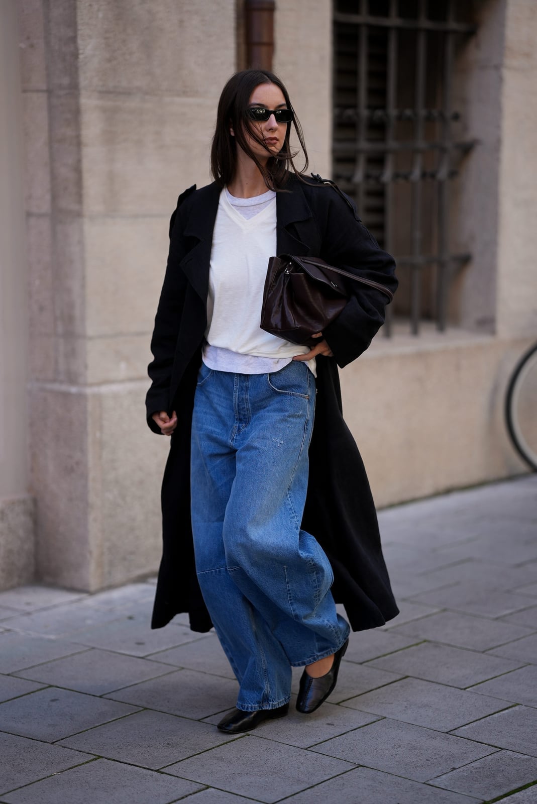 Long Black Trench Coat Over Baggy Blue Jeans Long Black Trench Coat Over Baggy Blue Jeans — Trendy Streetwear Outfits