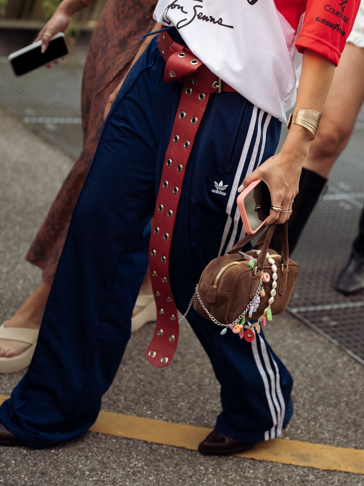 Navy Track Pants with Striped Shirt and Grommet Belt — Trendy Sweatpants Outfits