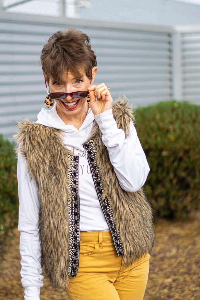 Hooded Sweatshirt Under Faux Fur Vest with Yellow Pants — Trendy Sweatshirt Outfits Women