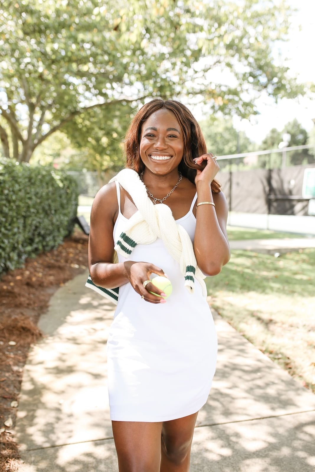 White Tank Dress with a Striped Sweater Accent White Tank Dress with a Striped Sweater Accent — Trendy Tennis Outfits