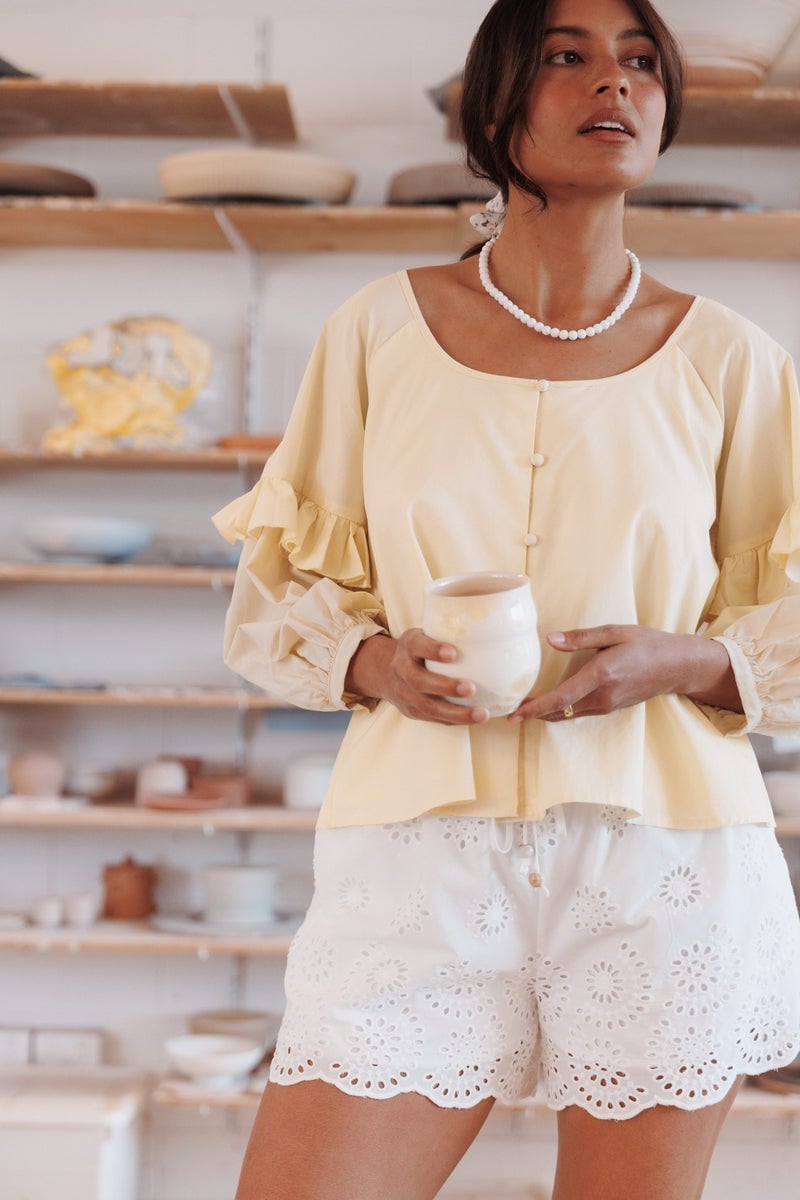 Pale Yellow Ruffled Sleeve Blouse and White Eyelet Shorts Pale Yellow Ruffled Sleeve Blouse and White Eyelet Shorts — Trendy Two Piece Outfits