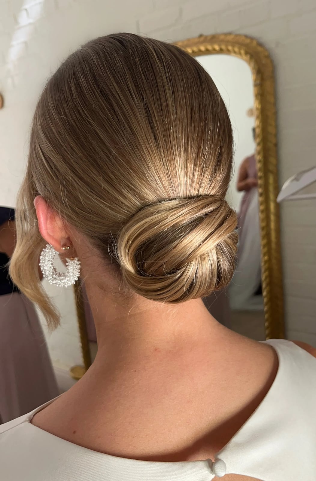 Ash Blonde Smooth Polished Low Bun Ash Blonde Smooth Polished Low Bun — Trendy Wedding Guest Updos