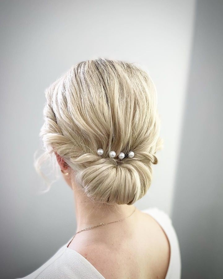 Blonde Twisted Low Bun With Pearls Blonde Twisted Low Bun With Pearls — Trendy Wedding Guest Updos