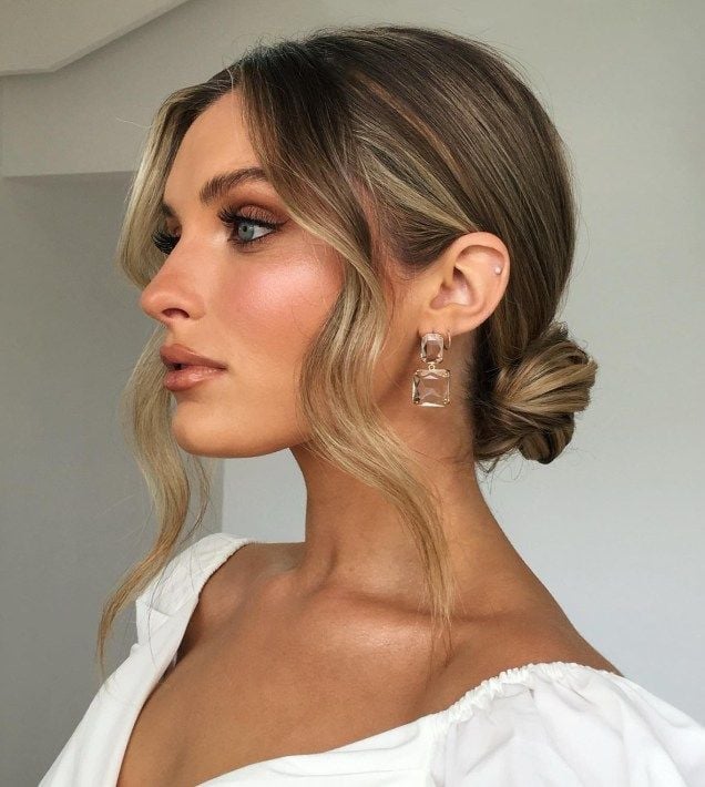 Dark Blonde Loose Low Bun With Curtain Bangs Dark Blonde Loose Low Bun With Curtain Bangs — Trendy Wedding Guest Updos