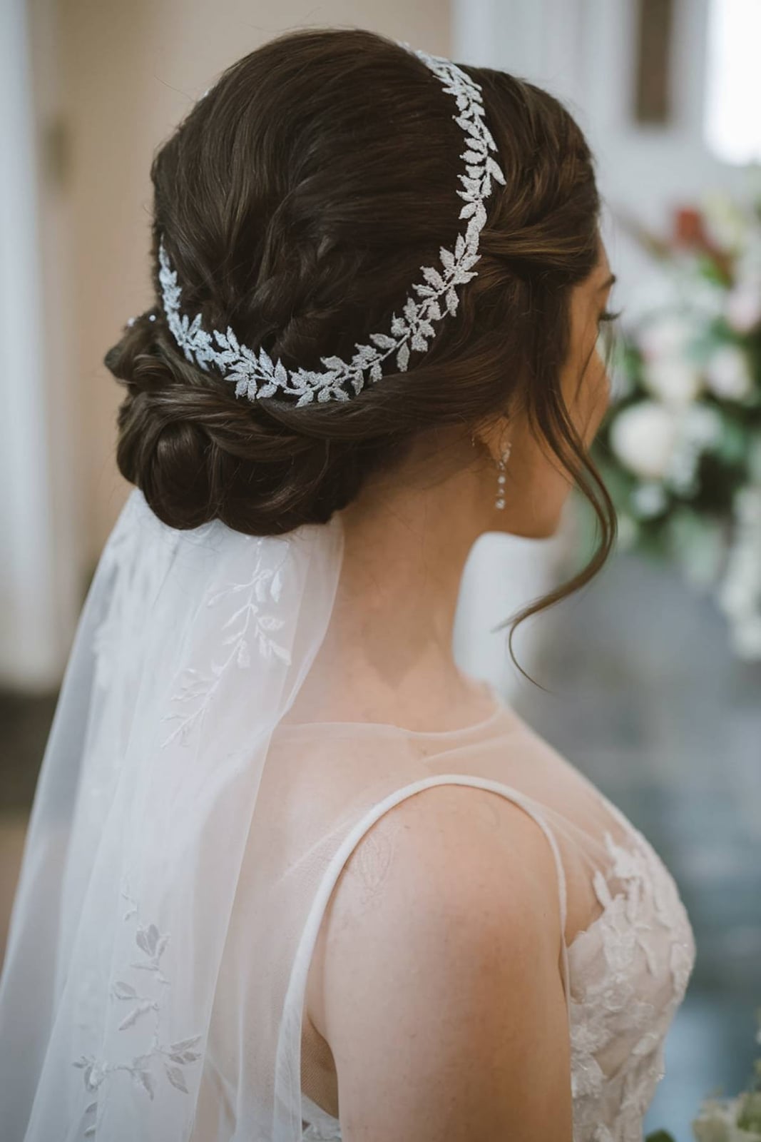 Dark Brown Braided Low Bun With Accessory — Trendy Wedding Hair