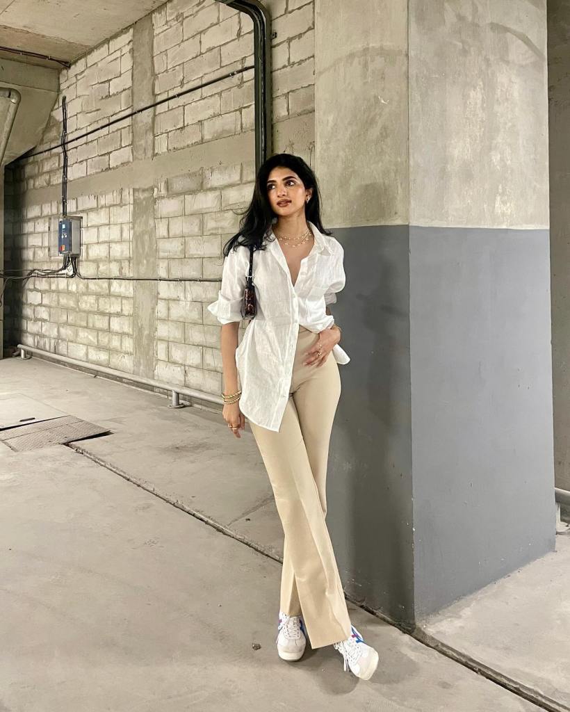 Asymmetrical White Shirt with Flared Beige Pants — Trendy White Shirt Outfits