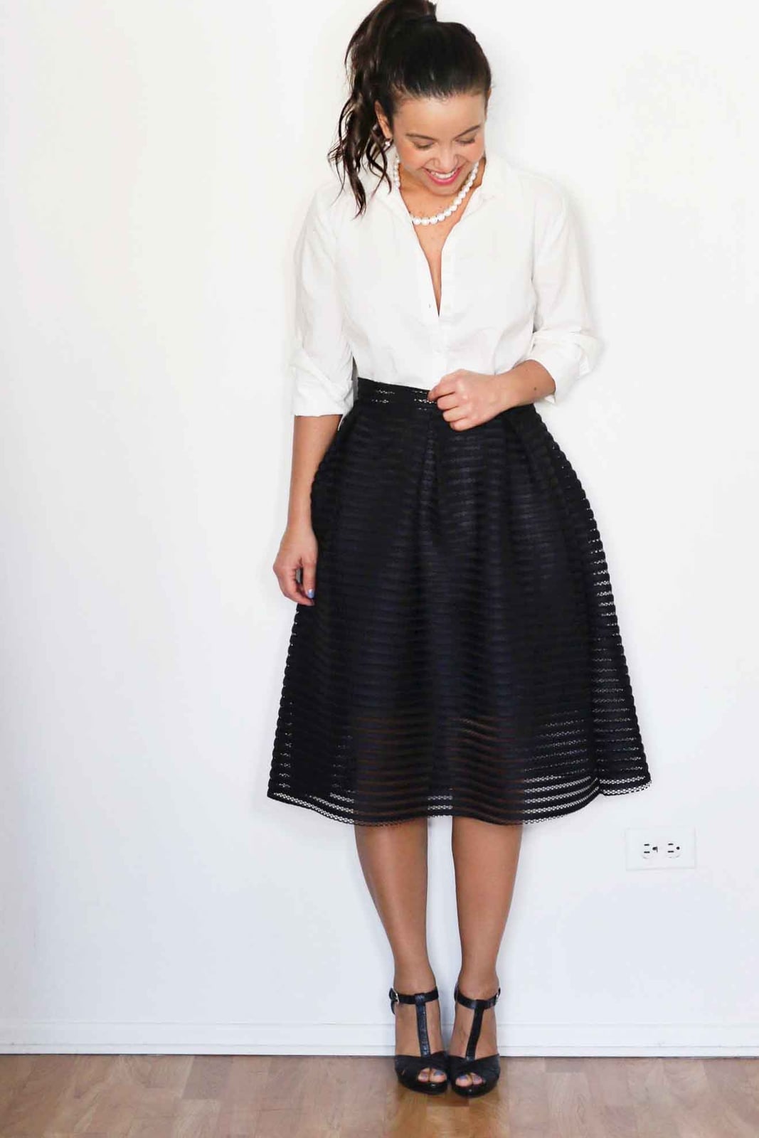 White Button-Down Shirt with Full Black Skirt and Pearl Necklace — Trendy White Shirt Outfits