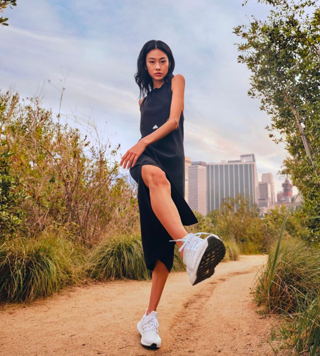 White Running Sneakers With Asymmetrical Black Dress White Running Sneakers With Asymmetrical Black Dress — Trendy White Sneakers Outfits