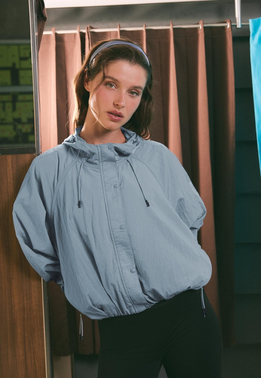 Light Blue Hooded Windbreaker with Black Leggings, Close-Up Take — Trendy Windbreaker Outfits