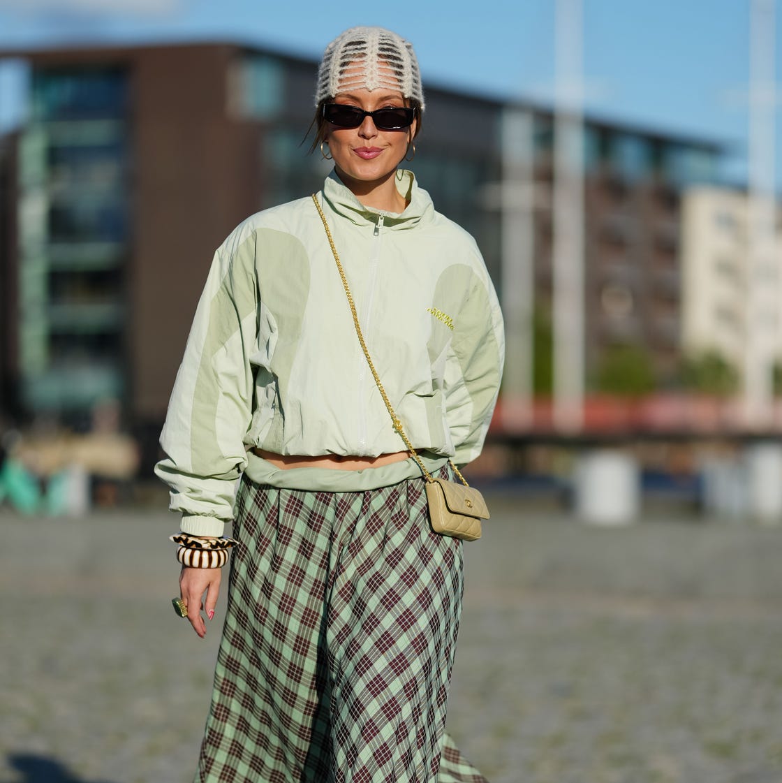Light Green Cropped Windbreaker with Plaid Midi Skirt, Close-Up Take — Trendy Windbreaker Outfits