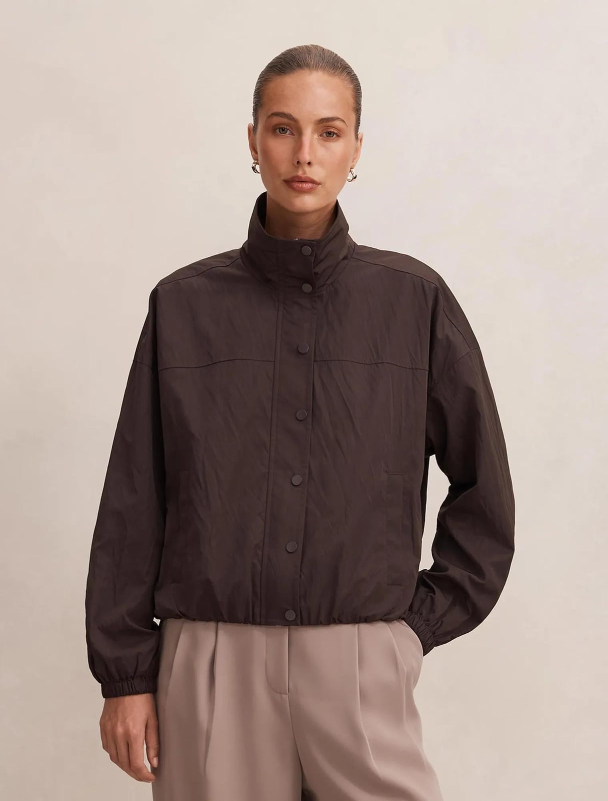 Brown Funnel Neck Windbreaker with Beige Trousers — Trendy Windbreaker Outfits