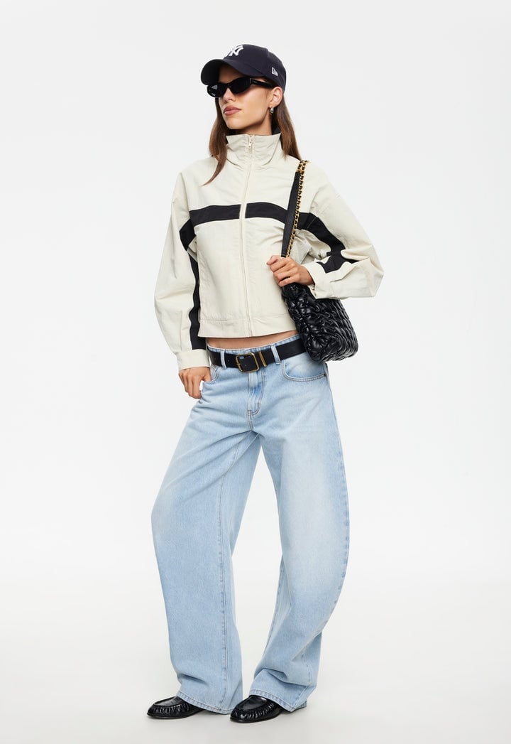 Cream Striped Windbreaker with Wide-Leg Jeans, Close-Up Take — Trendy Windbreaker Outfits
