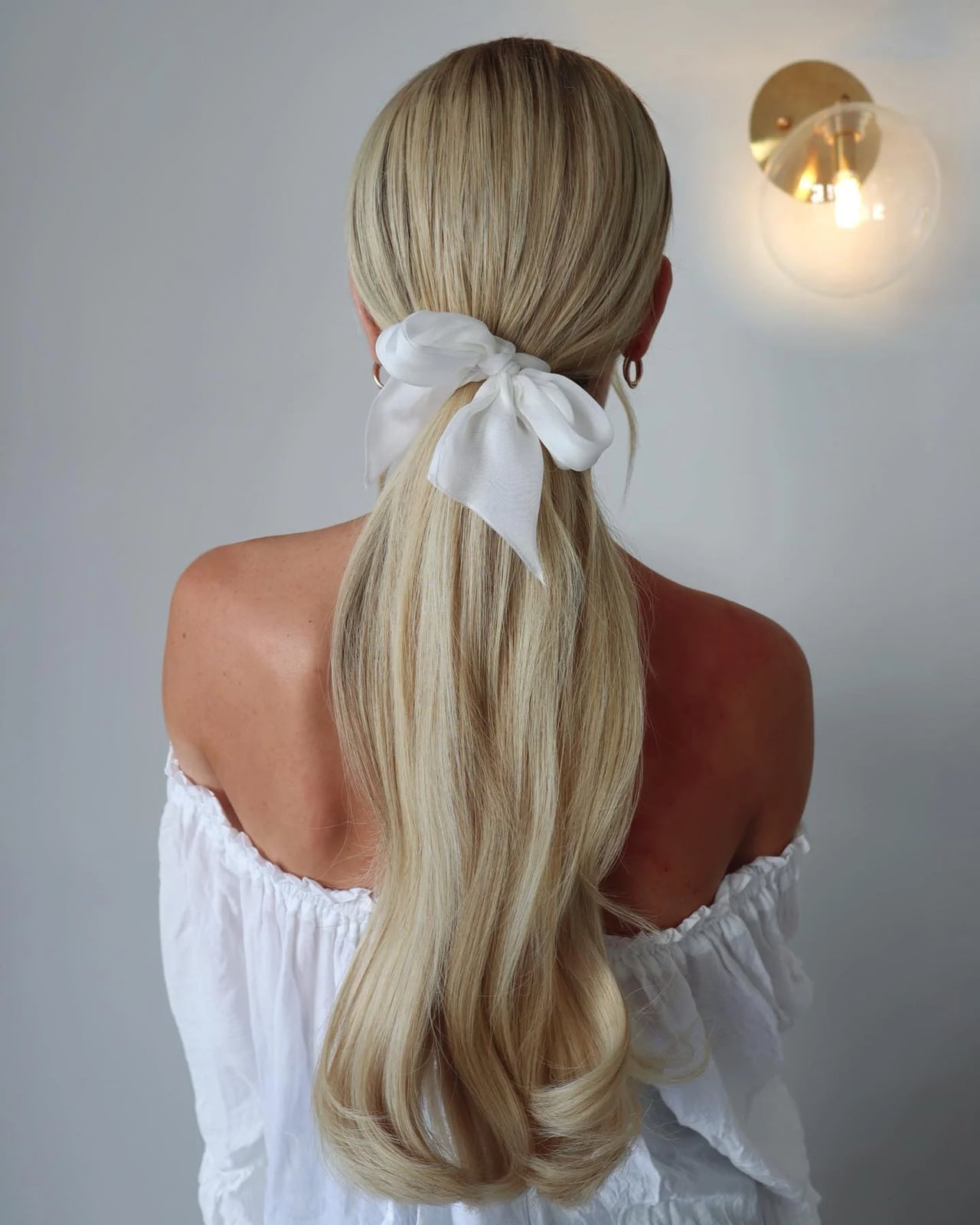 Mid-Back Ash Blonde Ponytail With Bow — Trendy Work Hair
