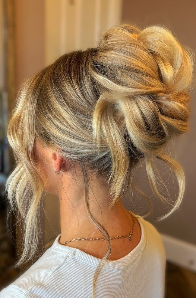Messy Blonde High Bun With Loose Tendrils Messy Blonde High Bun With Loose Tendrils — Wedding Bun Ideas