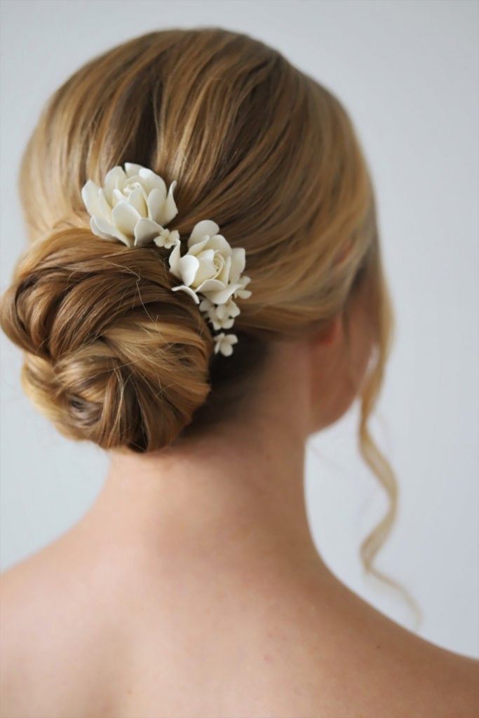 Low Blonde Bun With Floral Accessories Low Blonde Bun With Floral Accessories — Wedding Bun Ideas