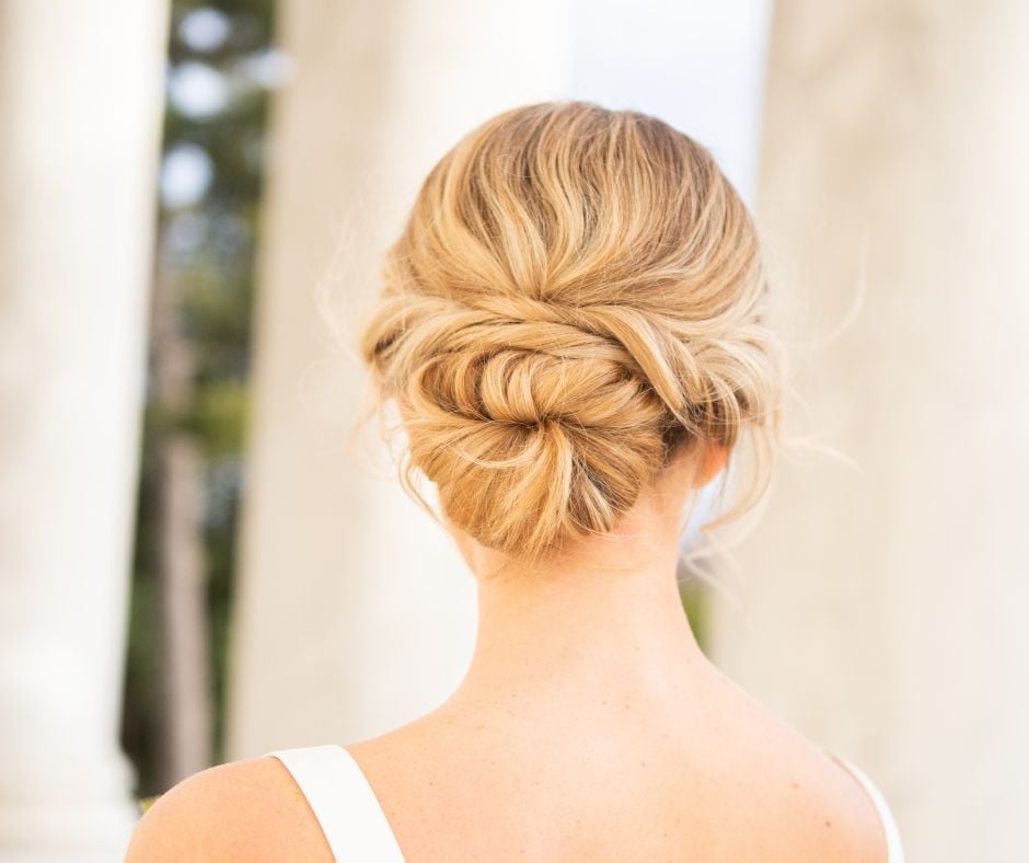 Low Blonde Twisted Bun With Loose Tendrils Low Blonde Twisted Bun With Loose Tendrils — Wedding Bun Ideas