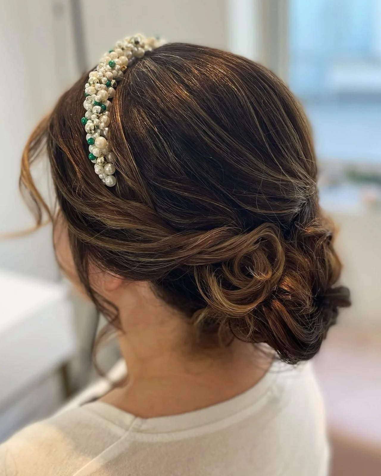 Low Twisted Updo With Wispy Bangs Low Twisted Updo With Wispy Bangs — Wedding Bun Ideas
