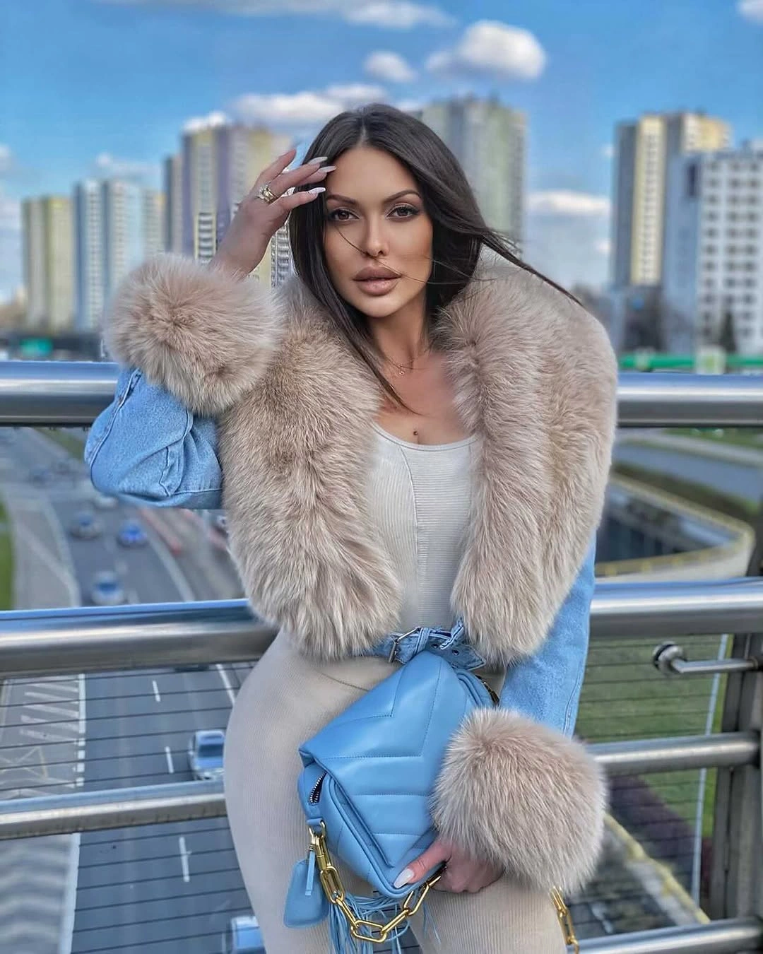 Powder blue jacket with oversized beige collar and matching blue handbag