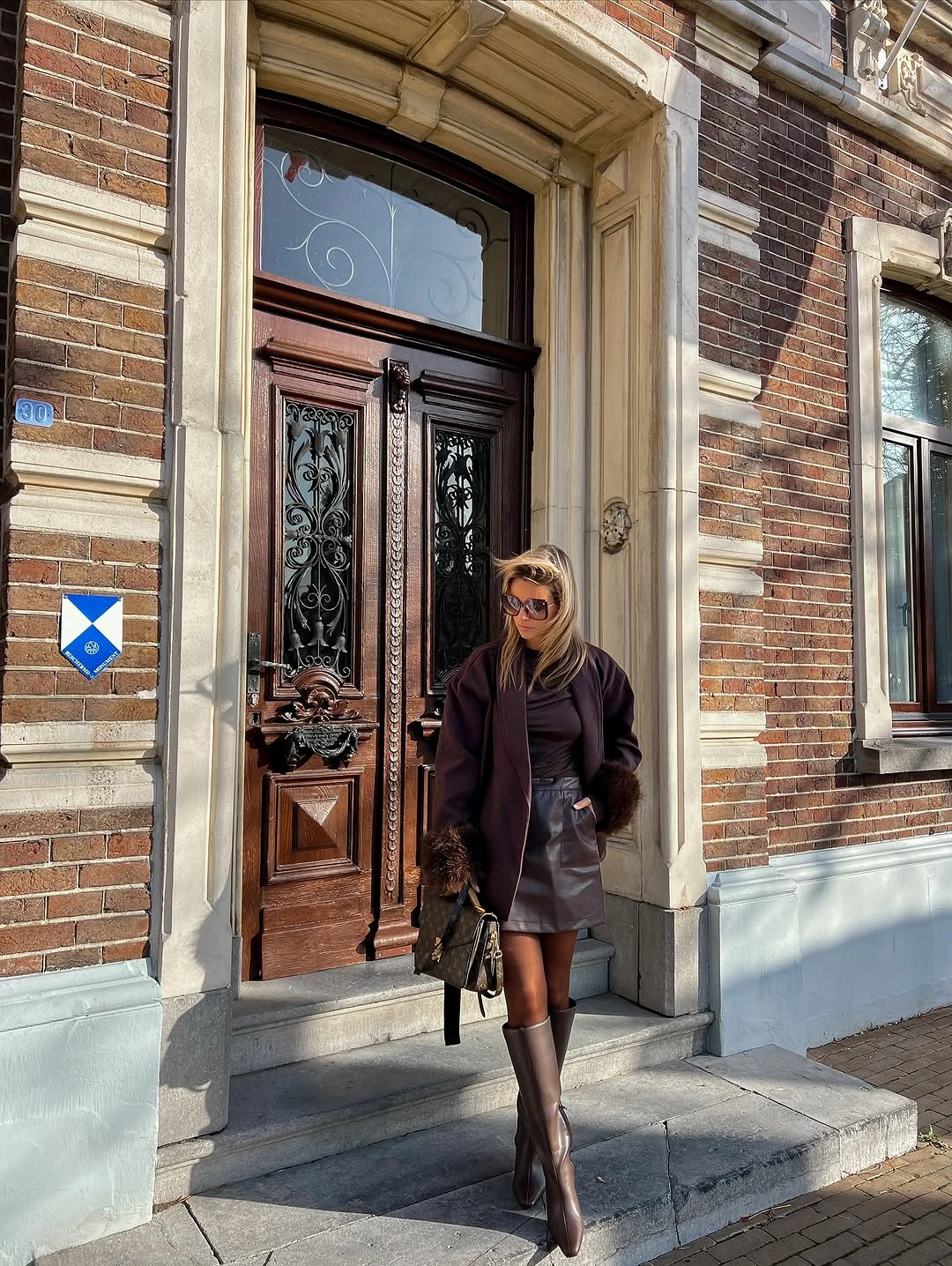 Dark plum brown jacket and short skirt with tall brown boots