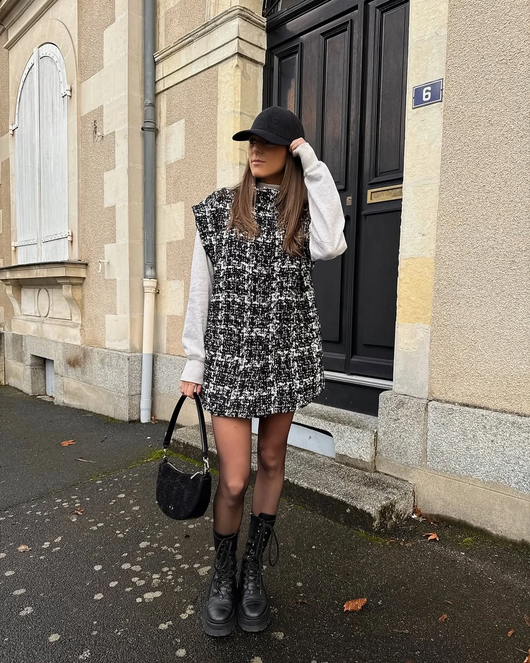 Patterned mini dress over white sleeves with tights and black boots