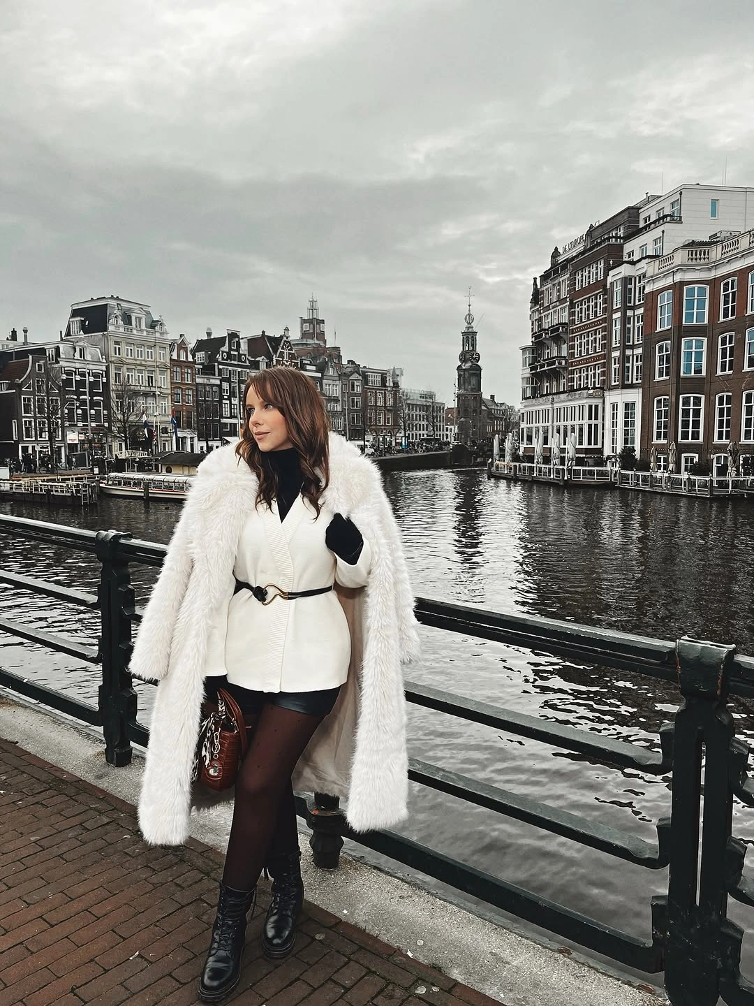 White belted jacket, shaggy coat, black shorts, tights, and boots