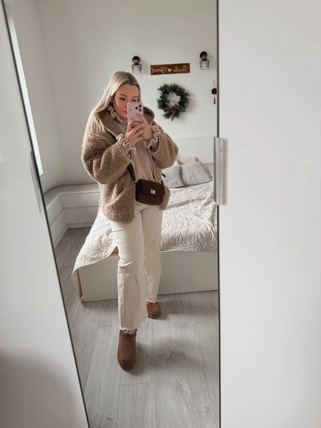 Taupe textured jacket, off-white jeans, brown boots, and crossbody bag